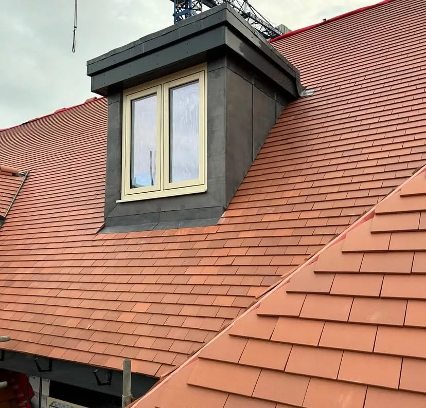 Clay tiled roof with a lead-clad dormer repaired and re-tiled in Hampshire