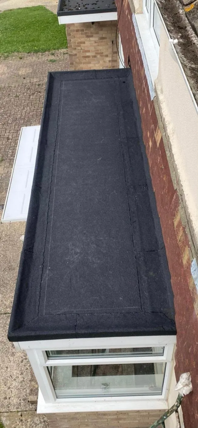 The same bay window roof finished with a new black felt covering and neat edge trims